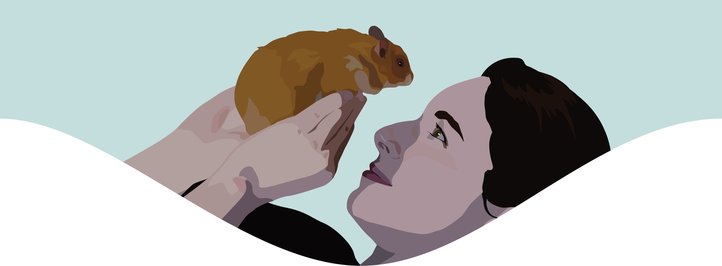 A woman holds a Syrian hamster up in her hands, casting a shadow on her face. She looks at the hamster with a smile.